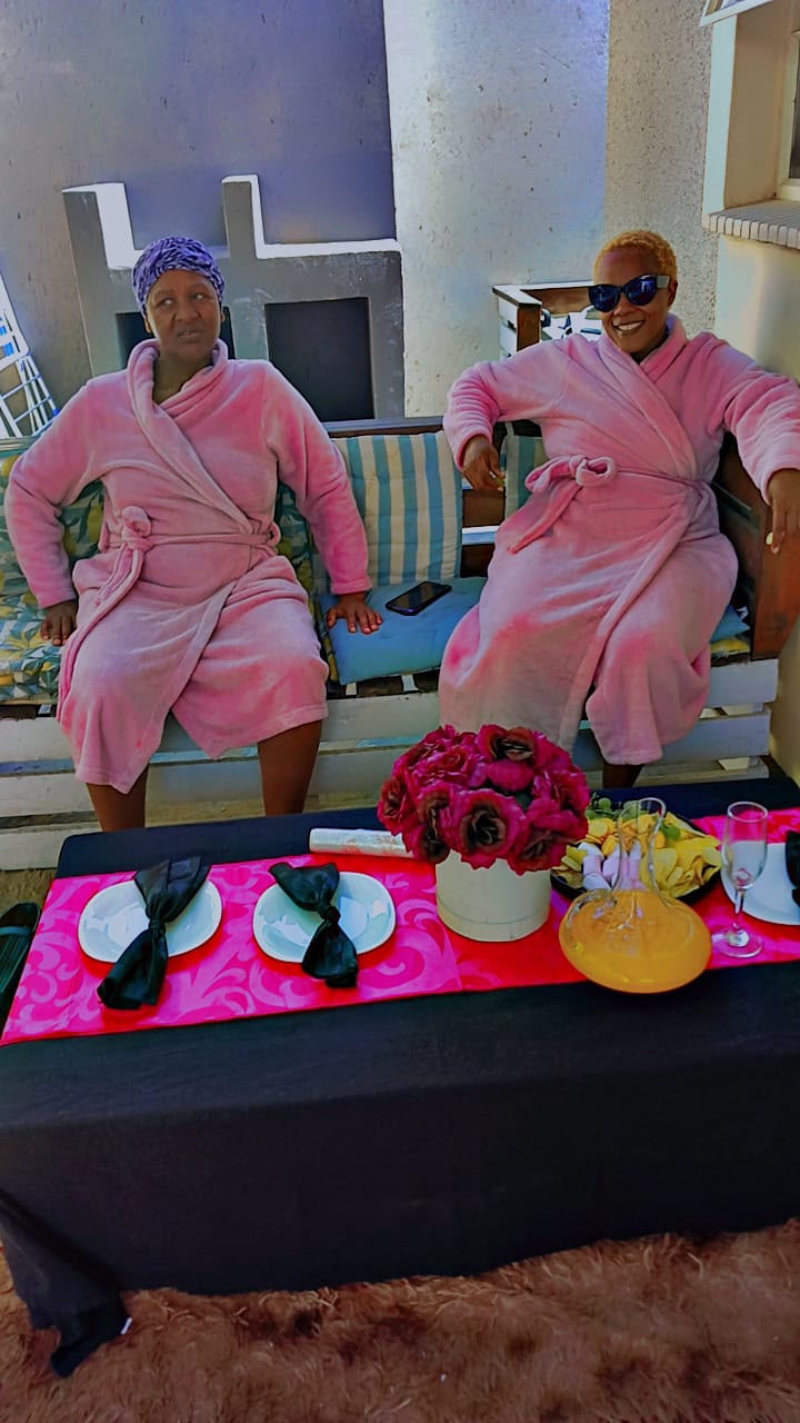 Guests relaxing in robes with a spa breakfast table at Bahumi Guesthouse