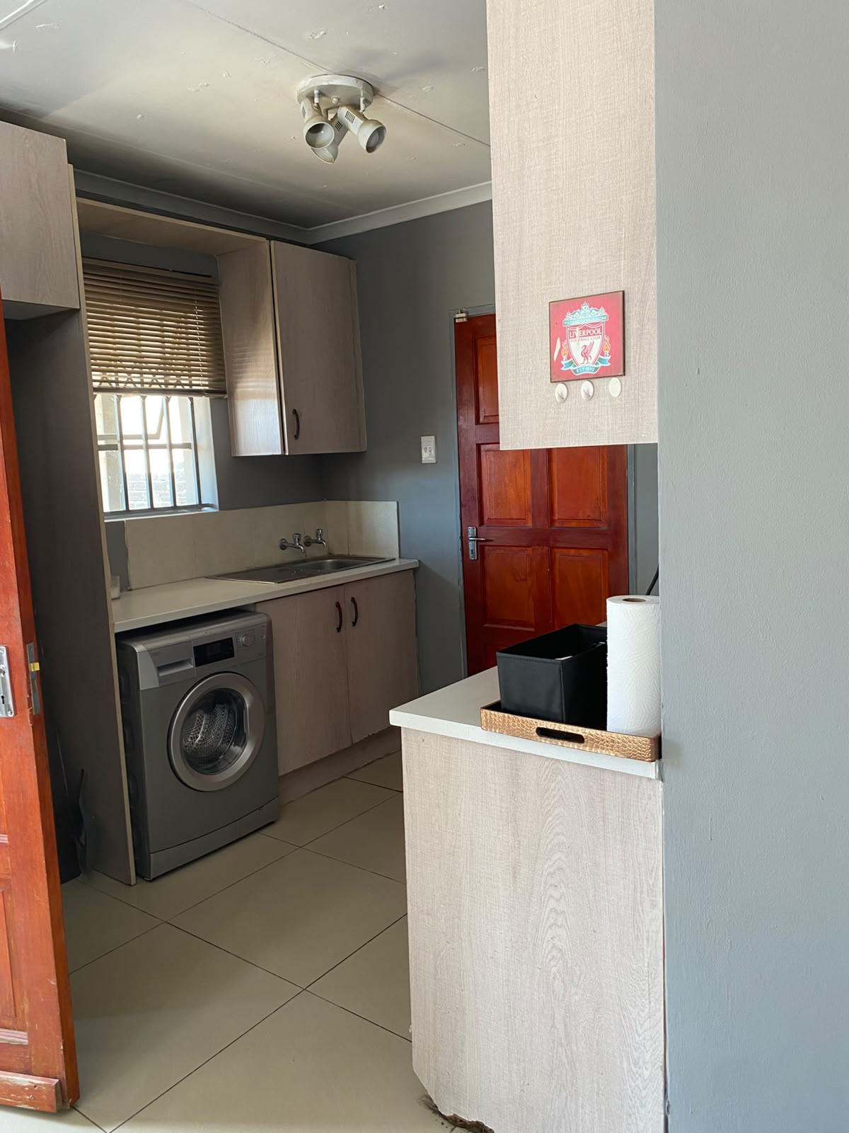 Room 6 private kitchenette with sink, cupboards and washing machine
